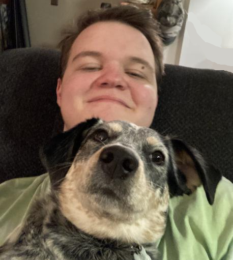 A picture of myself and my dog in front of me.